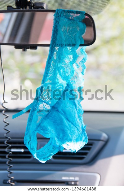 women\'s panties\
hang on the mirror in the\
car