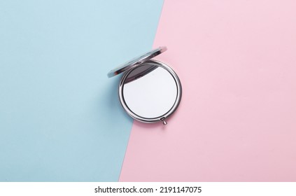 Women's portable make-up mirror on a blue-pink pastel background. Top view - Shutterstock ID 2191147075