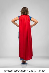 Women's Power And People Concept - Back View Of Young Woman In Red Superhero Cape Over Grey Background