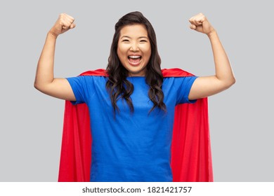 Women's Power And People Concept - Happy Asian Woman In Red Superhero Cape Over Grey Background