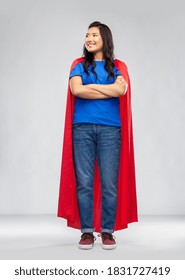 women's power and people concept - happy asian woman in red superhero cape over grey background