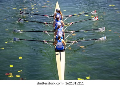 Women's quadruple rowing team on turquoise green lake - Powered by Shutterstock