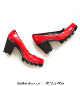 Women's Red Shoes Of Patent Leather On Black Platform Isolated On White Background. Square Image. Close Up.