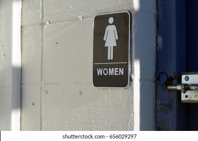 Women's Restroom Sign At Boarded Up Beach Pavilion 