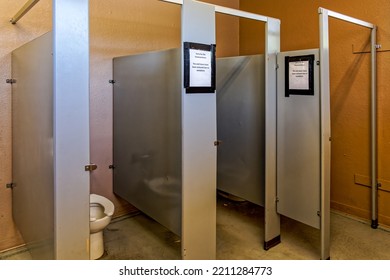 Womens Restroom With Stall Doors Removed. Sign Says Sorry For The Inconvenience.. The Stall Doors Have Been Rmoved Due To Vandalism