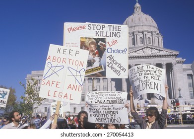 Women's rights marchers holding signs at State Capitol Building, Missouri