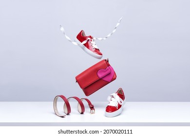 Women's shoes and accessories flying in the air on a light background. Fashionable women's items. Fashionable and modern womens handbag and shoes - Shutterstock ID 2070020111