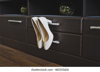 Womens Shoes Hanging In The Closet.