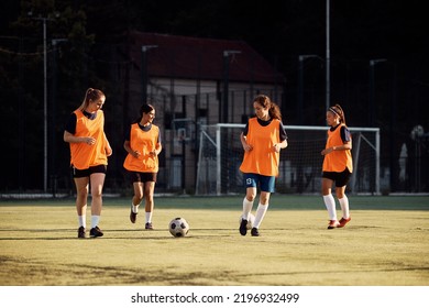 Women's Soccer Team During Practice On Playing Field. Copy Space.