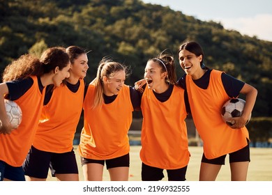 Women's Soccer Team Embracing While Their Captain Cheers Them On At The Stadium.