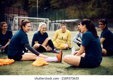 Women's Soccer Team And Their Coach Talking While Relaxing After The Practice At The Stadium.