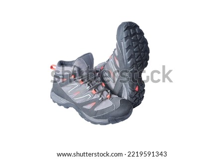women's trekking boots on a white background. mountain women's tourism concept. hiking boots on light texture. shoes for working on light surfaces
