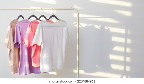 women's t-shirts on  hanger on  white background - Powered by Shutterstock