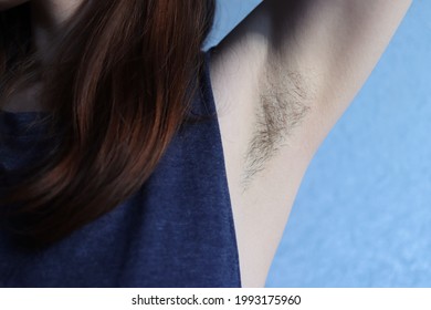 Women's unshaven armpit. Hair on the female body. Feminism for naturalness and against marketing-imposed beauty standards. Natural trend