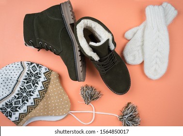 Women's Warm Clothing. Winter Clothes And Shoes. Background Of Coral Color. Top View, Flat Lay