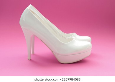 Women's white high-heeled shoes isolated on pink background. Elegant footwear. Beauty fashion idea concept. Copy space, blank, empty. Horizontal photo. No people, nobody. Stiletto - Shutterstock ID 2359984083