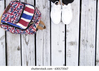 Women's white sneakers and backpack - Shutterstock ID 630173567