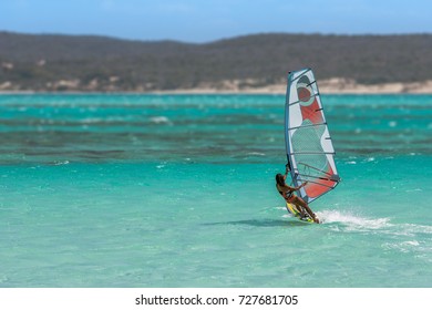 Women's Windsurfer Surfing In The Lagoon