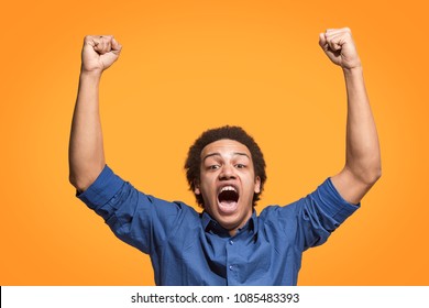 I won. Winning success happy man celebrating being a winner. Dynamic image of caucasian male model on orange studio background. Victory, delight concept. Human facial emotions concept. Trendy colors - Shutterstock ID 1085483393