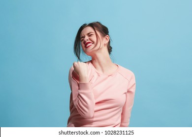 I won. Winning success happy woman celebrating being a winner. Dynamic image of caucasian female model on blue studio background. Victory, delight concept. Human facial emotions concept. Trendy colors