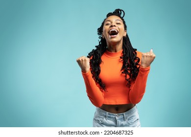 I won. Winning success happy woman celebrating being a winner. Dynamic image of female model on blue background. Victory, delight concept. Human facial emotions concept. Trendy colors - Shutterstock ID 2204687325