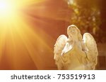 wonderful angel in the rays of the sun (architecture, statue, archetype, religion, faith concept)