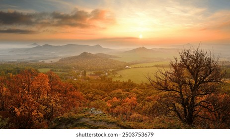 Wonderful beautiful amazing autumn fall sunrise in landscape of Czech Central Mountains, colorful clouds, fields and trees, serenity and peace - Powered by Shutterstock