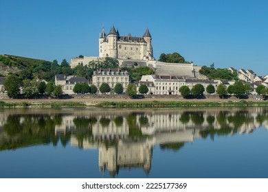 Wonderful castle of saumur reflected on the river in a beautiful sunny day