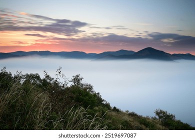 Wonderful foggy misty autumn morning with colorful dawn sunrise in Czech Central Mountains, hills above inversion and low clouds in Elbe river valley canyon - Powered by Shutterstock