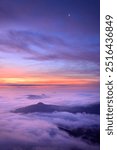 Wonderful foggy misty morning with colorful dawn sunrise in Czech Central Mountains, hills above inversion and low clouds