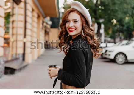 Similar – Image, Stock Photo Young woman and French bulldog on tree trunk at the beach