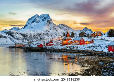 Wonderful landscape on Lofoten islands in winter season. Impressive Winter scenery with snowcapped mountains, traditional red fisherman huts, rorbuer. Reine village of an ideal resting place. - Powered by Shutterstock