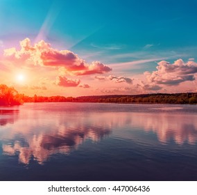 Wonderful landscape. the overcast sky, heavy storm clouds over the water. Dramatic, beautiful scene in the evening on the lake in the woods. Beauty in the world.  Retro and vintage style, soft filter. - Powered by Shutterstock