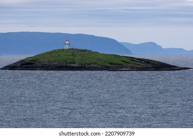 Wonderful landscapes in Norway. Nord-Norge. Masholmen Island Lighthouse. Scenic coastline in the north of Norway, Europe. Rocky skerries, seagulls. Islands in background. Rippled sea. Selective focus