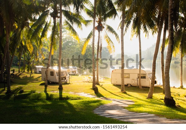Wonderful morning of family vacation travel RV\
nearby lake, holiday trip in motorhome, Caravan car Vacation.\
Beautiful Nature Thailand’s valley\
landscape.