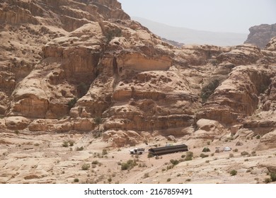 Wonderful mountain views on the Jordan Trail from Little Petra (Siq al-Barid) to Petra. A large Bedouin tent and off-road vehicle at the foot of the mountain.  Jordan, Hashemite Kingdom of Jordan 
