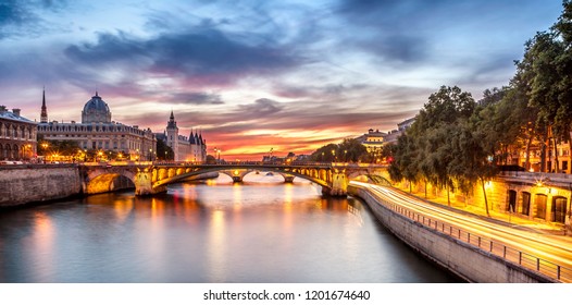 A Wonderful Night View Of Paris, Capital Of France. Where Its Buildings, Streets And Bridges Sparkle With Yellow Light