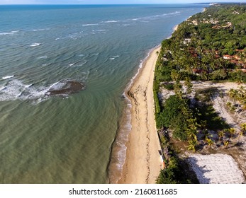 Wonderful Paradise Beach With The Summer Sun Rising In The Middle Of The Atlantic Forest. Tourist Town Arraial D'Ajuda, Brazil, South America. Aerial Drone View.