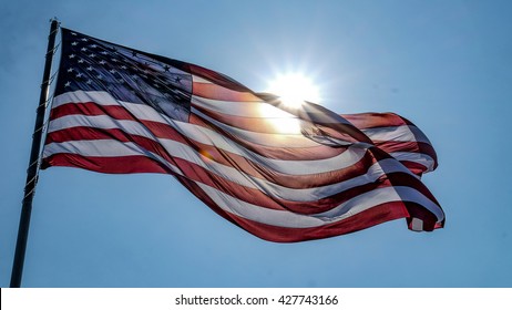 Wonderful Shot Of Waving American Flag With The Sun Behind