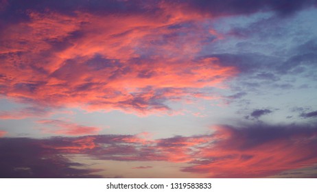 Wonderful sky in the evening with amazing colorful clouds bright red and blue. Beautiful cloudscape.