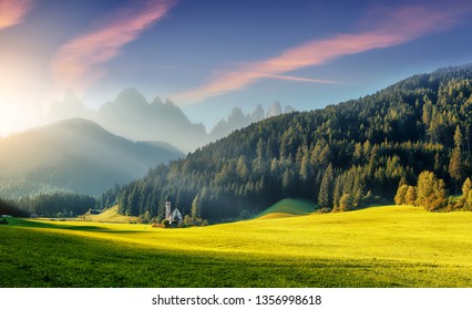 Wonderful Sunny Landscape Of Dolomite Alps. St Johann Church, Santa Maddalena, Val Di Funes, Dolomites, Italy. Fairy Velley In Dolomites Mountains Under Sunlit. Amazing Nature Background. Epic Scenery