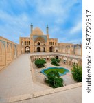 Wonderful view of Agha Bozorg Mosque on blue sky background in Kashan, Iran. The historical mosque and madrasa is a popular tourist attraction of the Middle East.