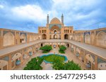 Wonderful view of Agha Bozorg Mosque on blue sky background in Kashan, Iran. The historical mosque and madrasa is a popular tourist attraction of the Middle East.