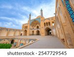 Wonderful view of Agha Bozorg Mosque on blue sky background in Kashan, Iran. The historical mosque and madrasa is a popular tourist attraction of the Middle East.