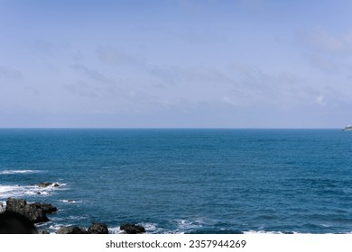 Wonderful view of Eo Gio beach- A tourist attraction in Quy Nhon, Binh Dinh, Vietnam with blue water and high rock cliffs. Ocean waves crashing against the rocky shore. Beach on windy day.  - Powered by Shutterstock