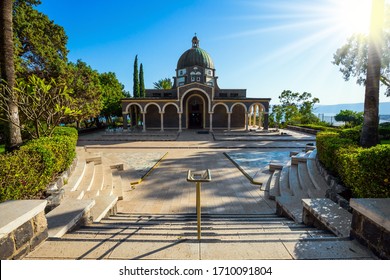 Wonderful winter day. Bright sunset lights illuminate the magnificent park. Church of the Beatitudes. High shore of Lake Tiberias. The concept of religious pilgrimage, ethnographic and photo tourism