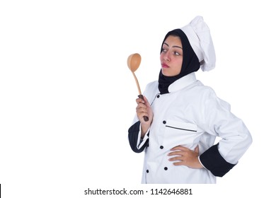 Wondering female chef wearing uniform standing hand on waist holds wooden ladle looking at it puzzled isolated on a white background. - Powered by Shutterstock