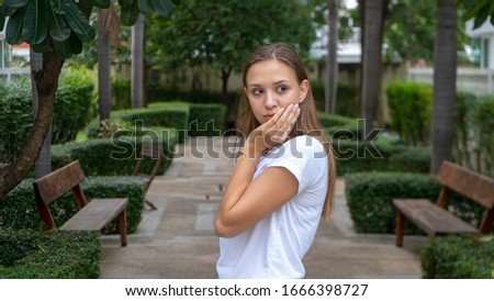 wondering teenager girl with hand on face