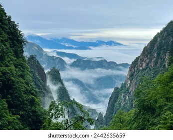 Wonderland view of the sea of clouds at West Sea Grand Canyon, Yellow Mountain (Huangshan), China. Misty clouds weave through emerald peaks, offering a majestic and tranquil feel - Powered by Shutterstock