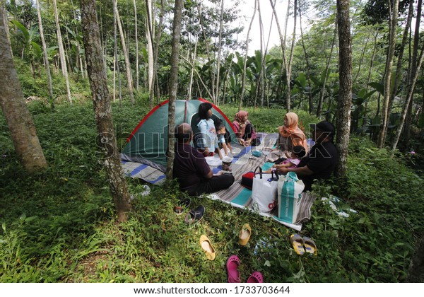 Wonosobo, Central Java, Indonesia. June 27-2018.\
family recreation by bringing a car and setting up a small tent in\
the garden